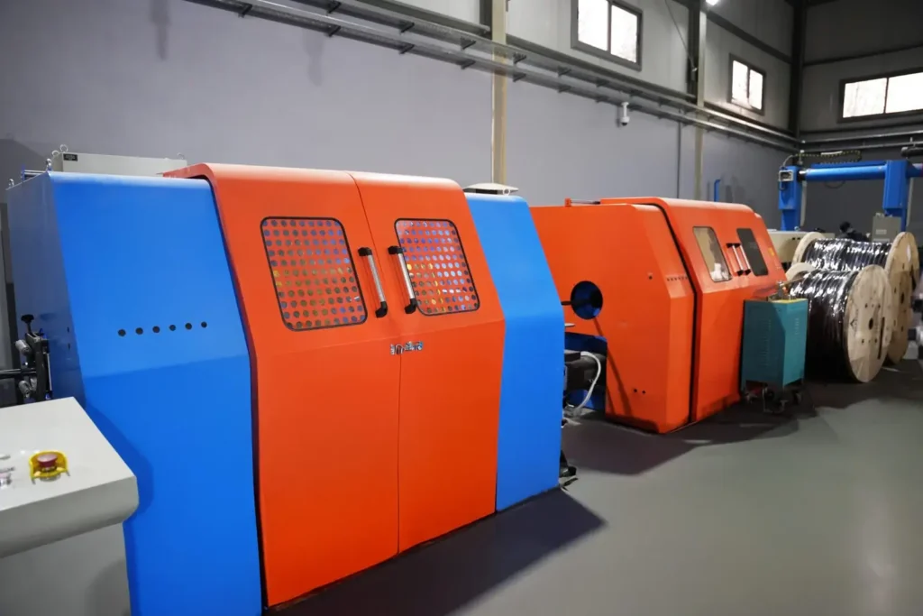 Cable manufacturing machines with large reels in production area.