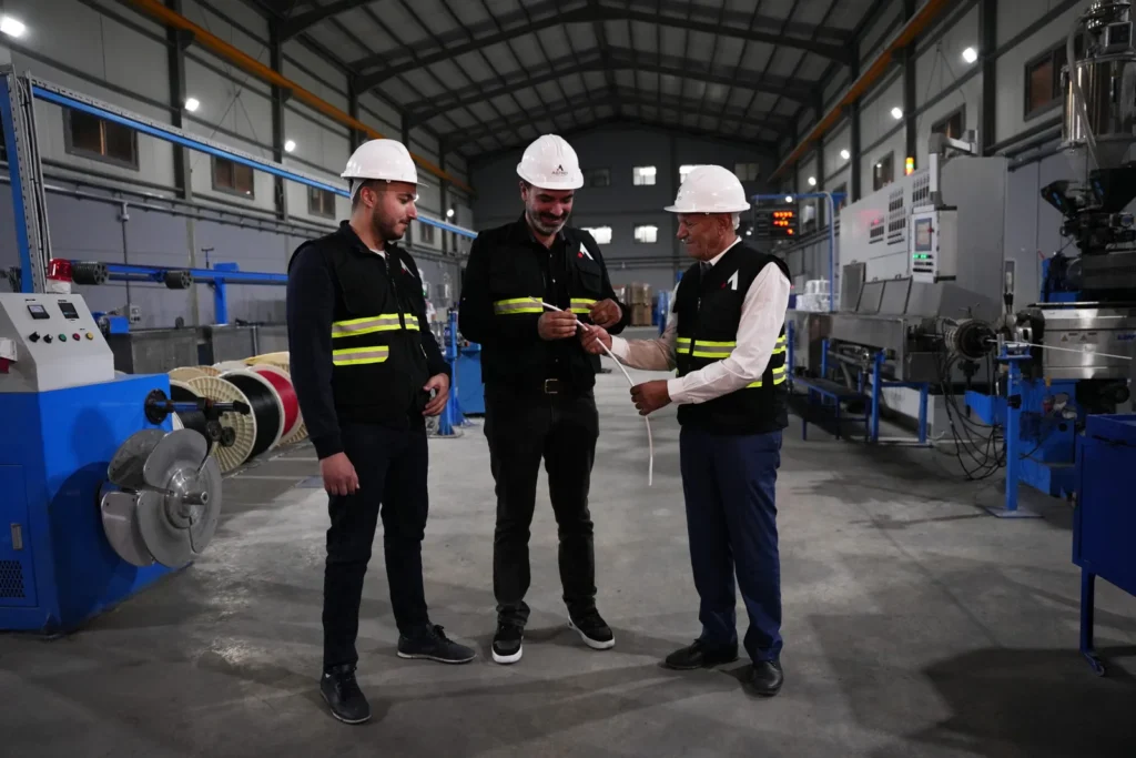 Astro Cables team collaborating on cable production in the factory.