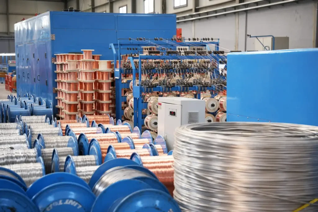 Cable production process at Astro Cables factory with copper and aluminum spools.