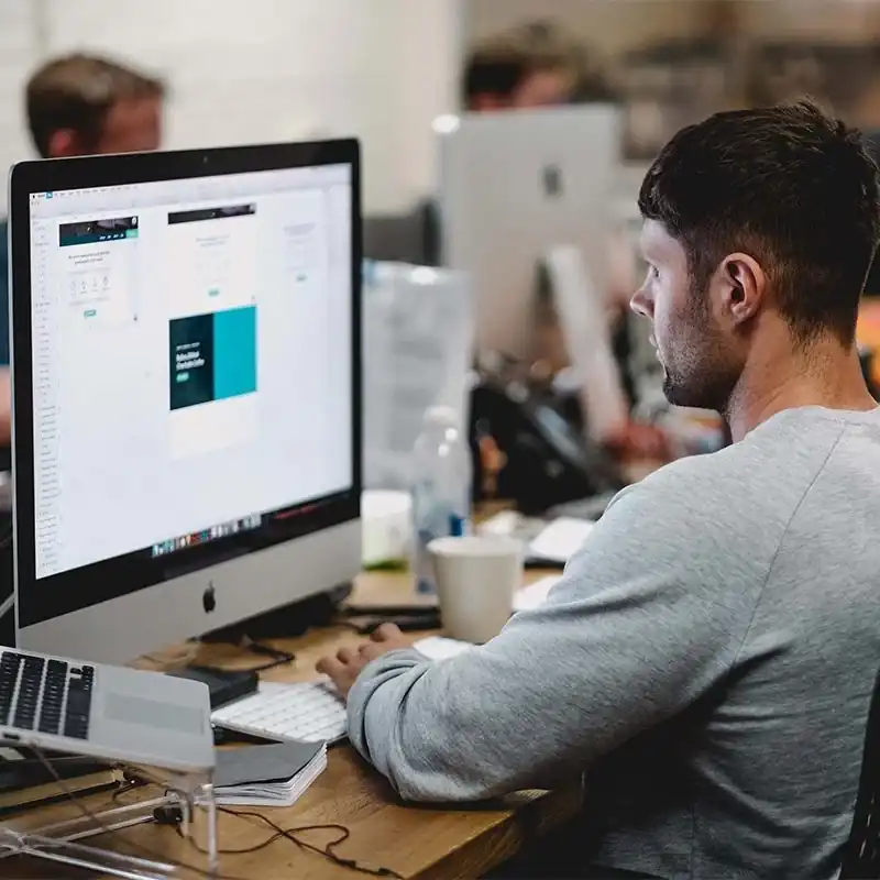 imageboxJob Employee working at Astro Cables office on a computer.